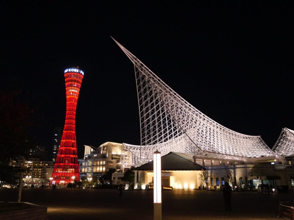 Kobe Port Tower and the Maritime Museum lit up at night in Meriken Park